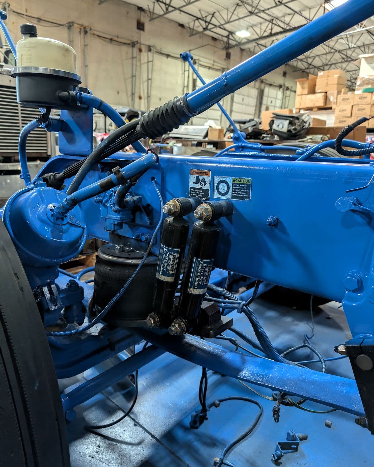Air tanks, lines and components mounted on the painted frame of a semi truck during a custom build