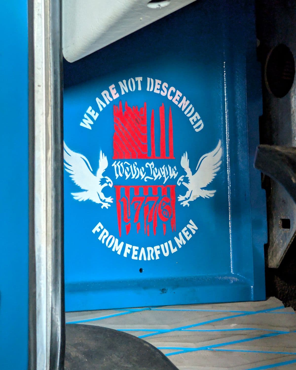 Custom painted panel inside a semi truck cab with the floor masked off for finish work