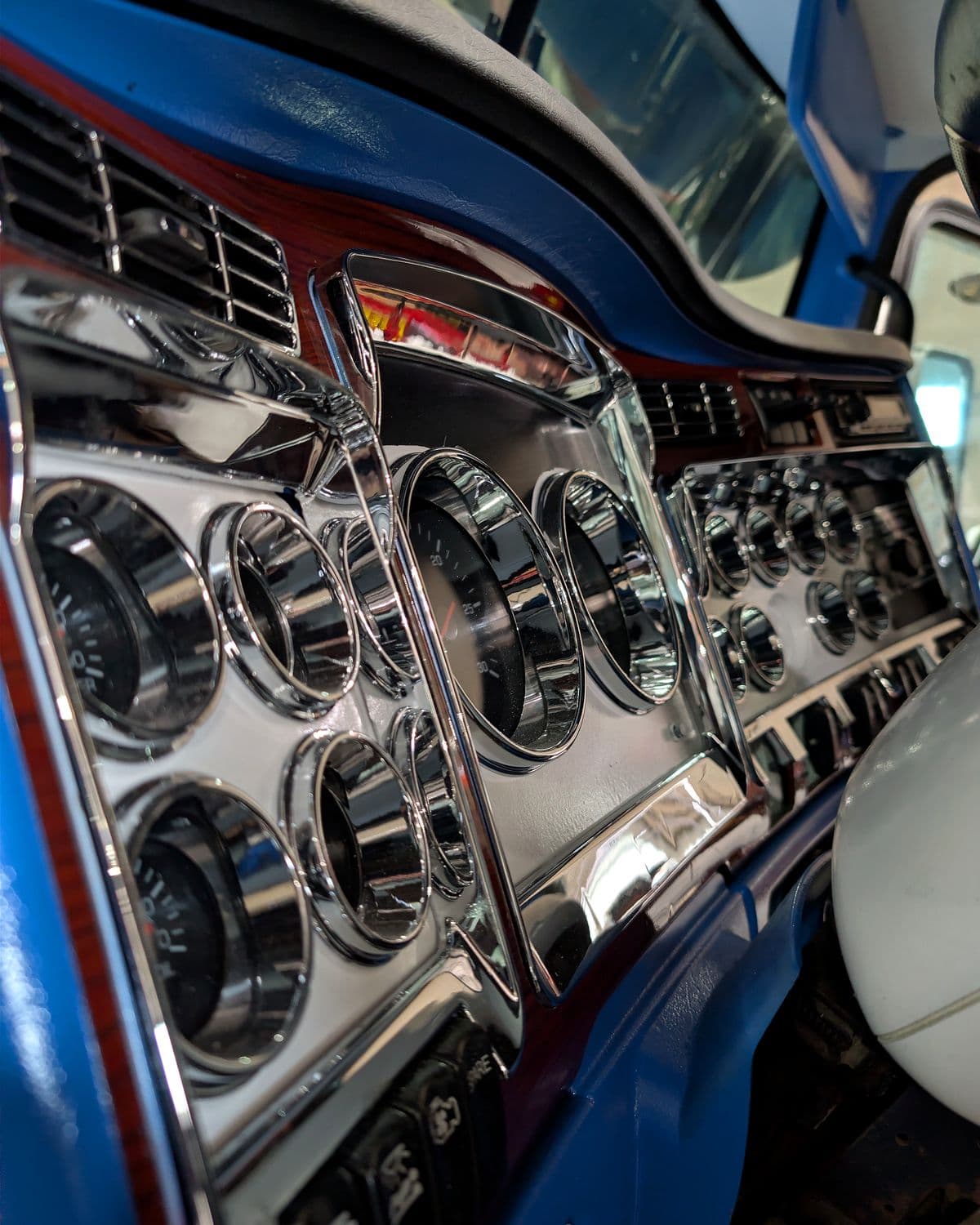 Custom chrome gauge cluster in the dash of a semi truck being custom built