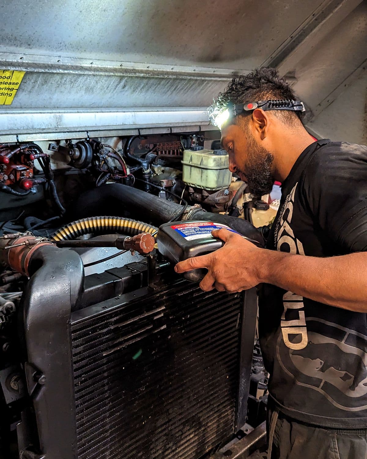 Emerald Fleet Services technician running diagnostics on a semi truck engine in the Sumner shop